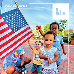 A group of young children holding an American Flag