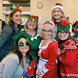 Library staff in variety of colorful holiday attire