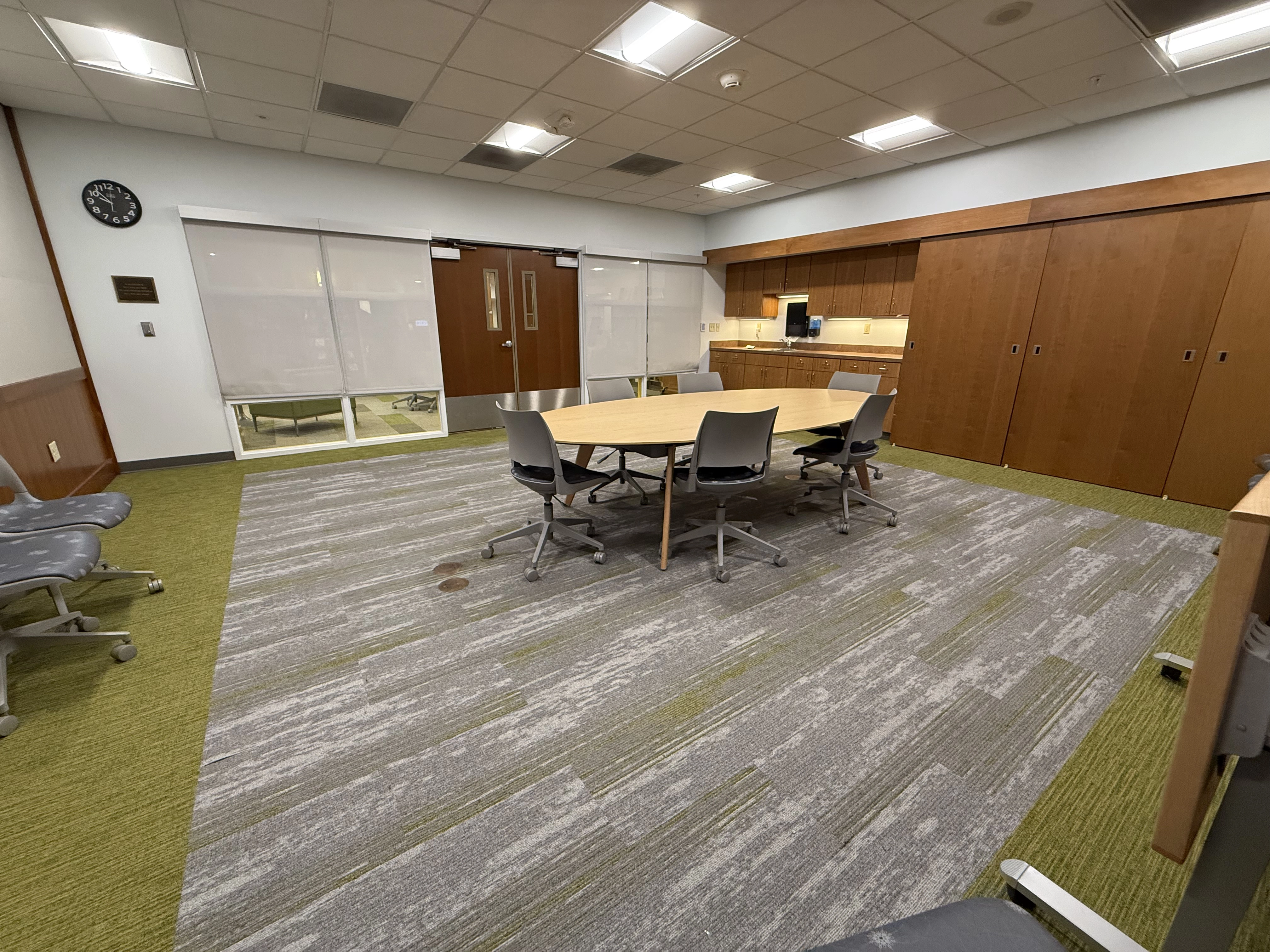 a view of the Trust room from the far right hand corner facing the door way showing a large oval table and chairs
