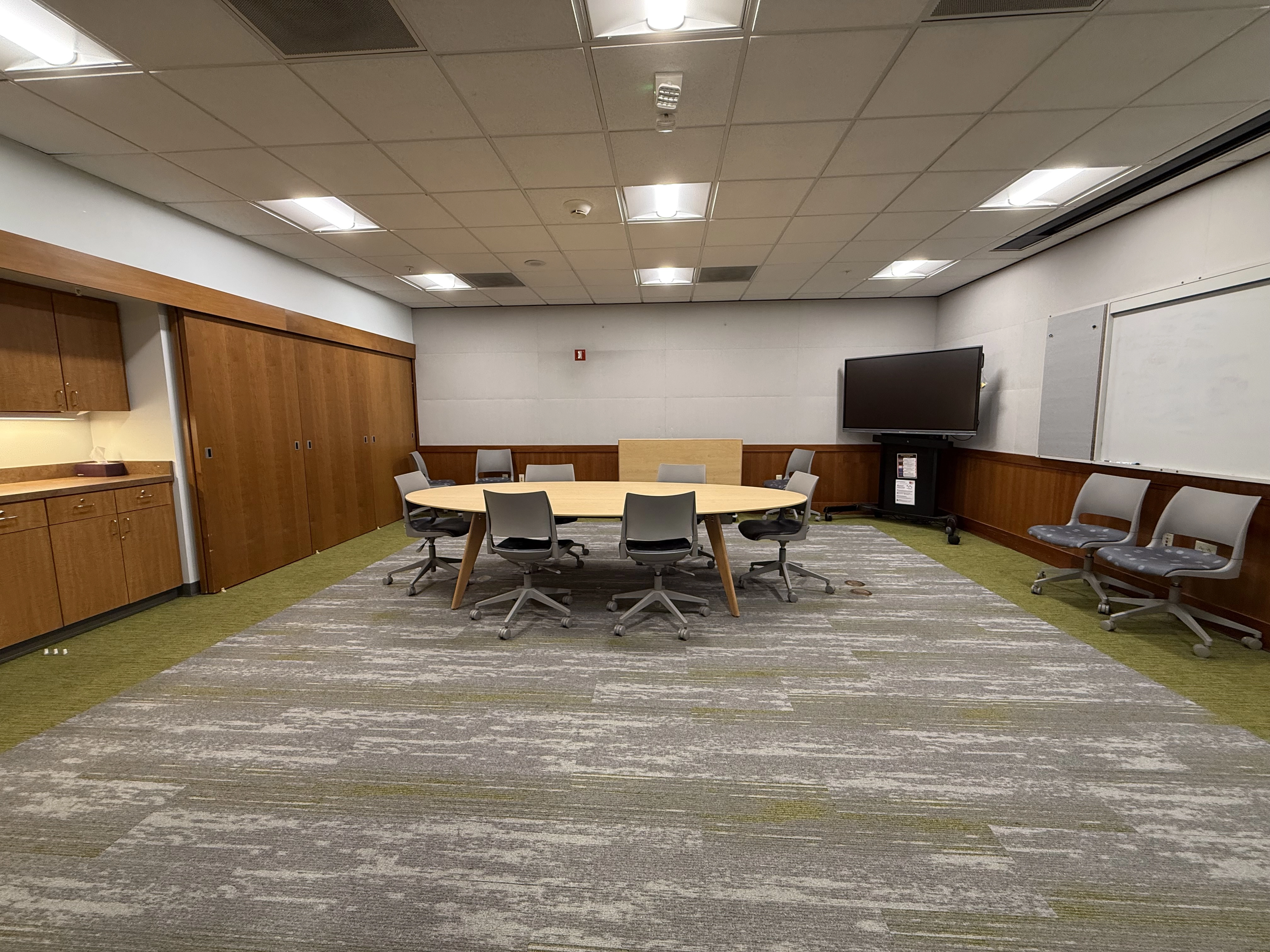 A view from the left hand side of the room facing the right wall with the large oval table and chairs