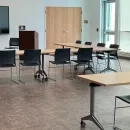 Community Room showing tables, chairs and a monitor on the wall
